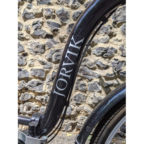 371 - A Jorvik tricycle in black with a basket to the front and rear, with a singular wicket basket, handl... 