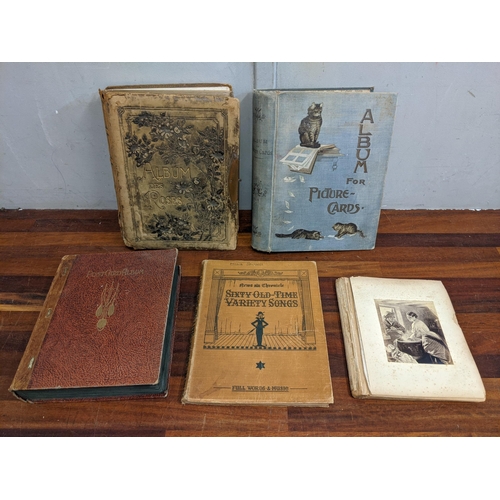 374 - Collectables to include a Victorian photograph album, an album for picture cards and an album of pos... 