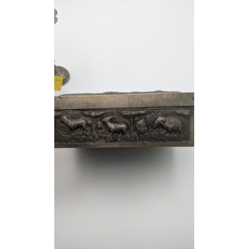 99 - India white metal to include an embossed box wit hinged lid depicting hunters and animals and an emb... 