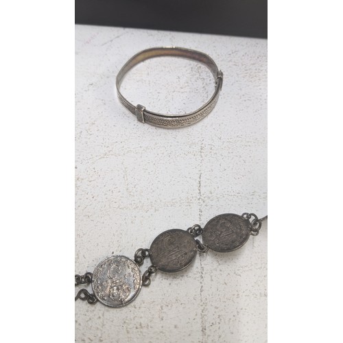 172 - Silver to include two British coin bracelets, a child's bangle, sterling silver pickle for, silver h... 