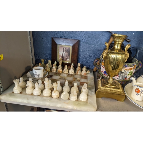 335 - A mixed lot to include an onyx chessboard, two pairs of binoculars, a Wedgwood clock and other items... 