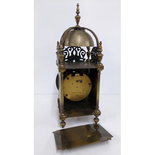 403 - An early 20th century reproduction of a 17th century brass cased lantern clock, having strap work be... 