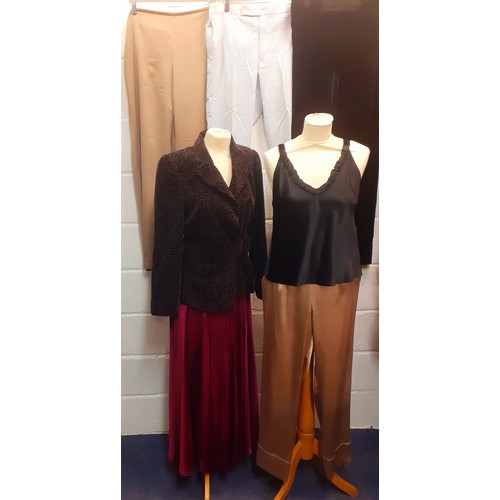 410 - A large mixed lot of ladies clothing to include an Emporio Armani crimson full length satin skirt Eu... 