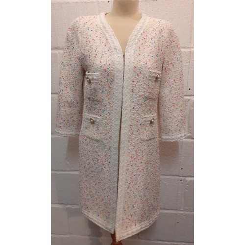 71 - An Edward Achour, Paris white ground boucle coat in the style of Chanel having multi coloured flecks... 