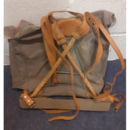 460 - A vintage canvas ,leather and metal framed backpack together with an early 20th Century tin hat box ... 