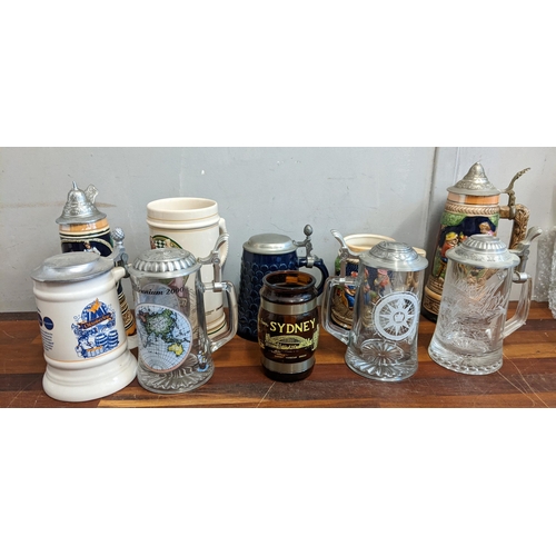 497 - A mixed lot to include a large collection of beer steins to include several German style ceramic exa... 