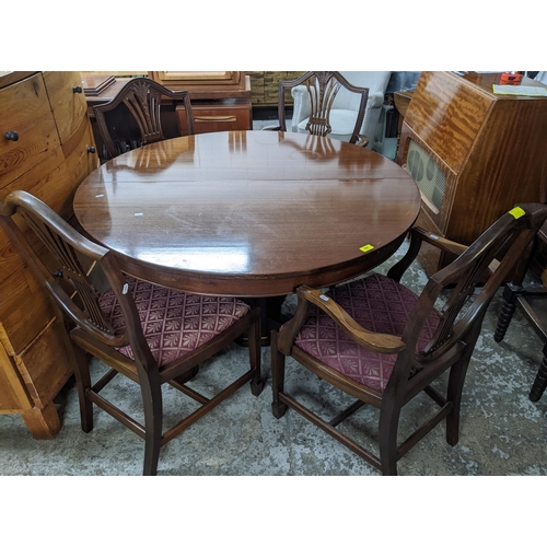 390 - A Victorian pedestal extending mahogany dining table with two extra leaves, and four later Hepplewhi... 