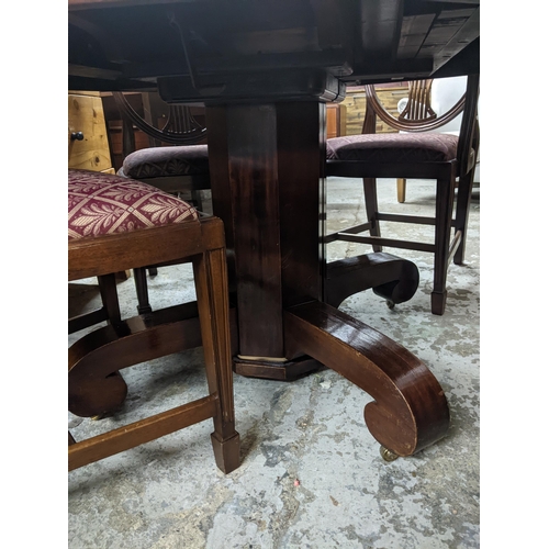 390 - A Victorian pedestal extending mahogany dining table with two extra leaves, and four later Hepplewhi... 