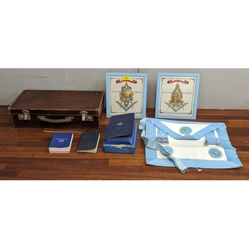 439 - Masonic related items to include a year book, a bible, a case, a dress apron and two pictures of mas... 