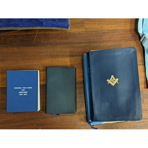 439 - Masonic related items to include a year book, a bible, a case, a dress apron and two pictures of mas... 