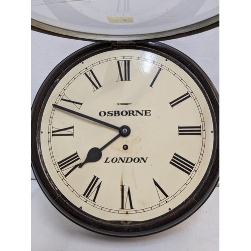 458 - An Osborne wall clock with London underneath in an oak case with a roman dial and a white face (two ... 