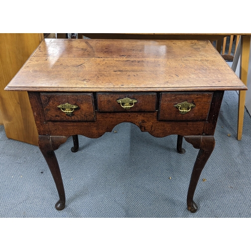 472 - An 18th century oak lowboy with three drawers on cabriole legs Location:A4M
If there is no condition... 