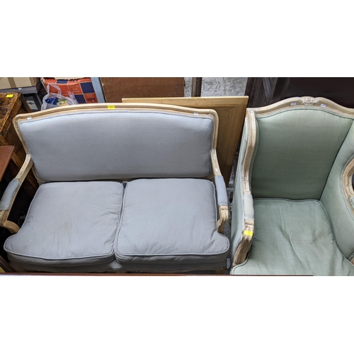 475 - A French style limed wood framed two seater sofa and matching armchair, upholstered loose cushion se... 