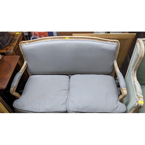 475 - A French style limed wood framed two seater sofa and matching armchair, upholstered loose cushion se... 