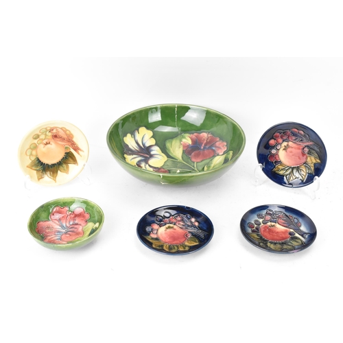 10 - A group of Moorcroft pottery to include a Walter Moorcroft 'Hibiscus' pattern bowl, a 'Finches Ochre... 