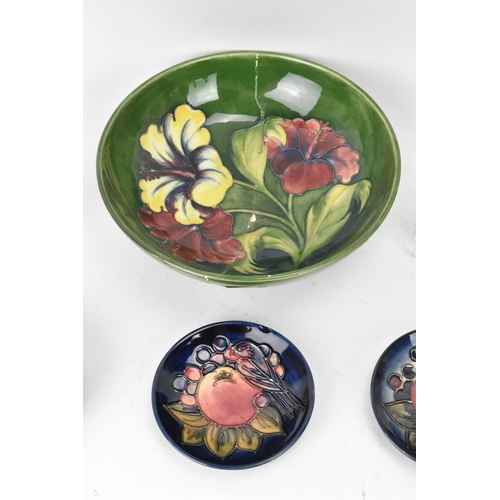 10 - A group of Moorcroft pottery to include a Walter Moorcroft 'Hibiscus' pattern bowl, a 'Finches Ochre... 