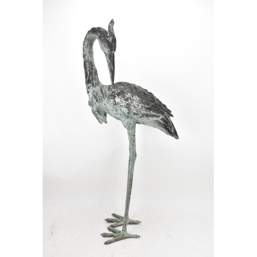 104 - Two 20th century large light green patinated cast bronze models of cranes, one mounted on a naturali... 