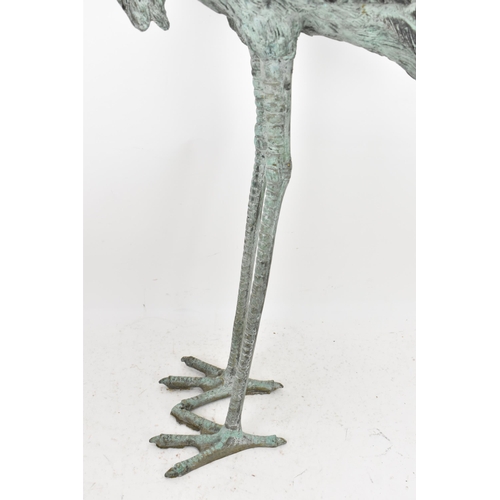 104 - Two 20th century large light green patinated cast bronze models of cranes, one mounted on a naturali... 