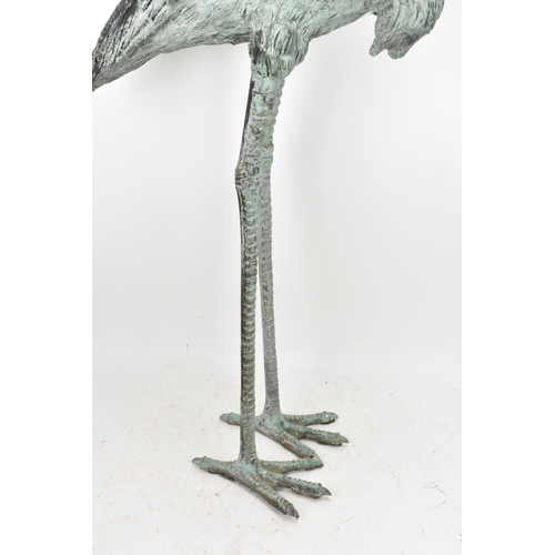 104 - Two 20th century large light green patinated cast bronze models of cranes, one mounted on a naturali... 