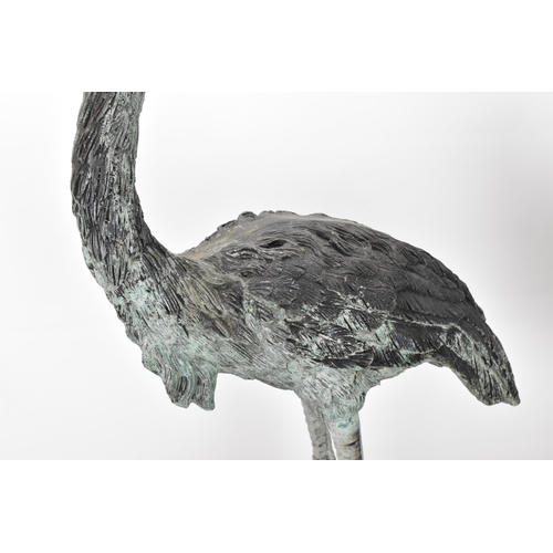 104 - Two 20th century large light green patinated cast bronze models of cranes, one mounted on a naturali... 