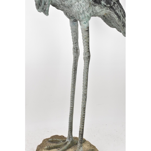 104 - Two 20th century large light green patinated cast bronze models of cranes, one mounted on a naturali... 