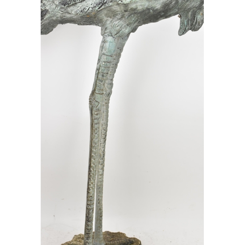 104 - Two 20th century large light green patinated cast bronze models of cranes, one mounted on a naturali... 