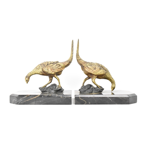 106 - After Antonio Amorgasti - A pair of 1930s bookends fashioned as gilded bronze models of pheasants on... 