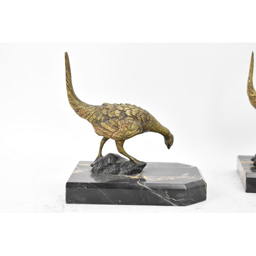 106 - After Antonio Amorgasti - A pair of 1930s bookends fashioned as gilded bronze models of pheasants on... 