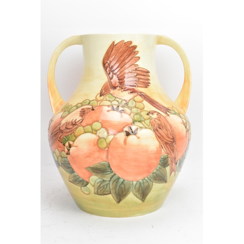 11 - A Moorcroft pottery large and impressive 'Finches Ochre' pattern twin handled vase, designed by Sall... 