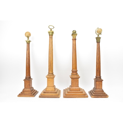 151 - Four early 20th century Masonic oak columns, two mounted with globes, each having a tapered column a... 