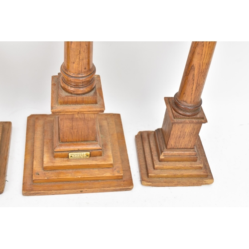 151 - Four early 20th century Masonic oak columns, two mounted with globes, each having a tapered column a... 