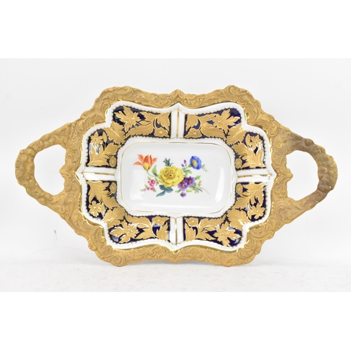 153 - A mid/late 20th century Meissen cabinet twin handled dish, having an ornate gilded relief border dec... 