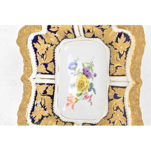 153 - A mid/late 20th century Meissen cabinet twin handled dish, having an ornate gilded relief border dec... 