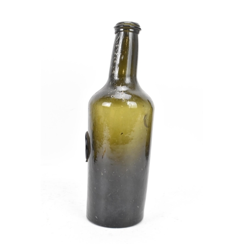 154 - An early 19th century glass seal wine bottle, the tapering neck with sloping rim, the cylindrical bo... 