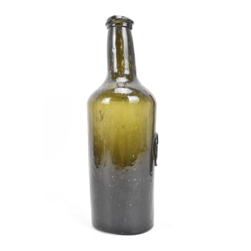 154 - An early 19th century glass seal wine bottle, the tapering neck with sloping rim, the cylindrical bo... 