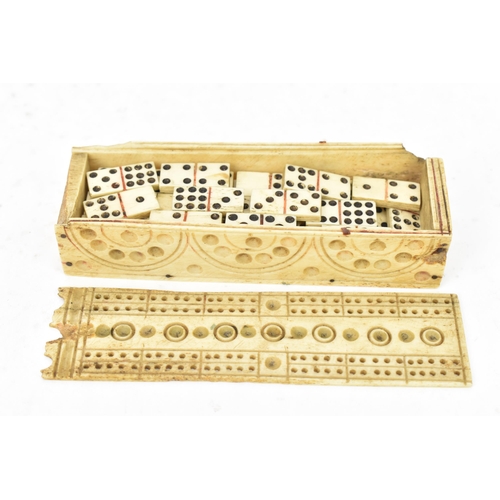 167 - A 19th century French prisoner of war bone domino set, the case sarcophagus formed with a sliding pa... 