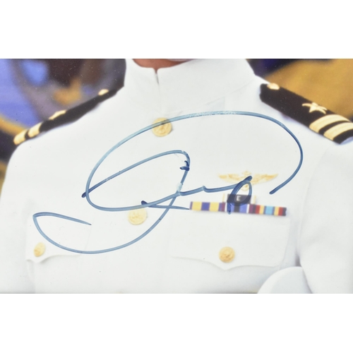 173 - A Tom Cruise signed colour photograph, the image depicting the actor in costume as Maverick from the... 