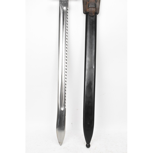 184 - A Swiss 1914 sawback bayonet, by Elsener Schwyz, length of blade 48cm, complete with steel scabbard ... 