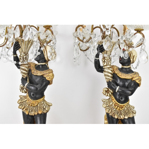 189 - A pair of mid 20th century treen painted blackamoor table lamps, each modelled as a boy holding a co... 