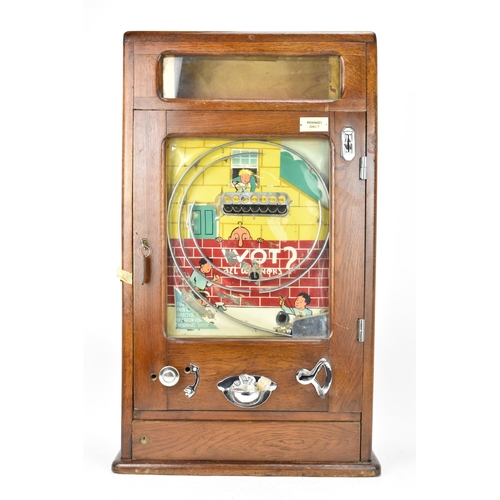 19 - An early/mid 20th century Chad penny oak cased penny slot machine, instructions to the bottom left, ... 