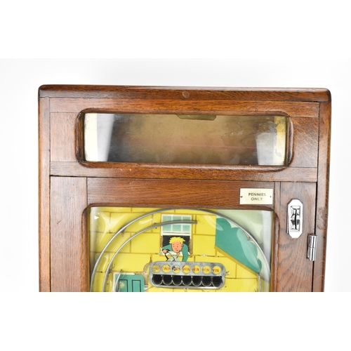 19 - An early/mid 20th century Chad penny oak cased penny slot machine, instructions to the bottom left, ... 