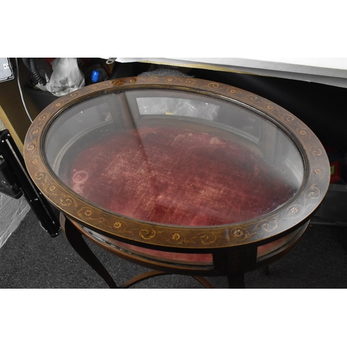 195 - An Edwardian mahogany and marquetry inlaid vitrine display table, of oval form, boxwood inlaid with ... 