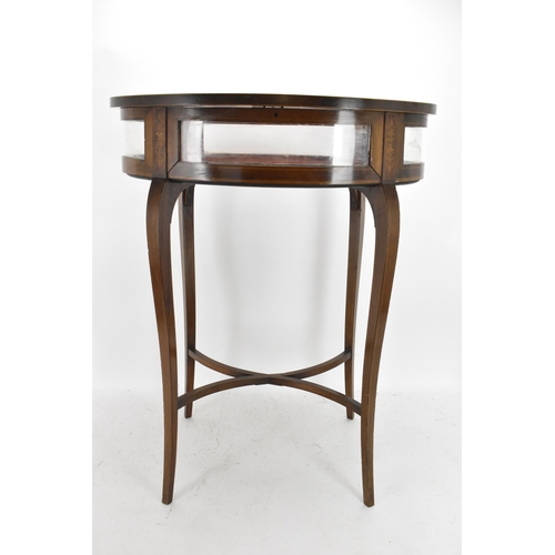 195 - An Edwardian mahogany and marquetry inlaid vitrine display table, of oval form, boxwood inlaid with ... 