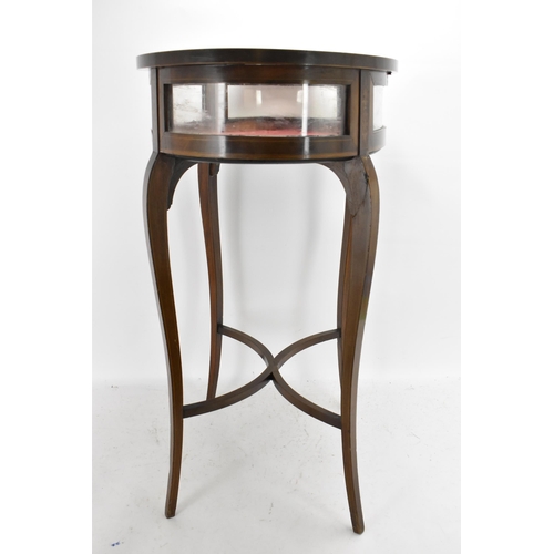 195 - An Edwardian mahogany and marquetry inlaid vitrine display table, of oval form, boxwood inlaid with ... 