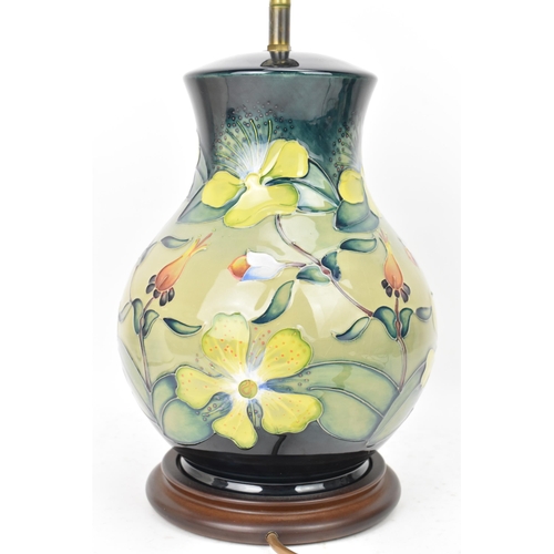 22 - A Moorcroft pottery 'Hypericum' pattern table lamp, designed by Rachel Bishop, of baluster form and ... 