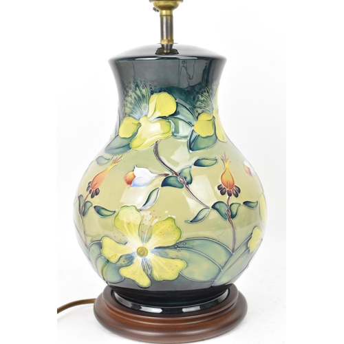 22 - A Moorcroft pottery 'Hypericum' pattern table lamp, designed by Rachel Bishop, of baluster form and ... 