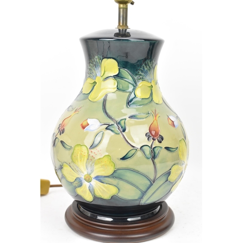 22 - A Moorcroft pottery 'Hypericum' pattern table lamp, designed by Rachel Bishop, of baluster form and ... 