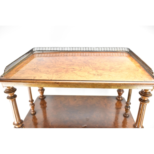 226 - A Victorian figured burr walnut three tier whatnot, having a gilt metal gallery top above three tier... 