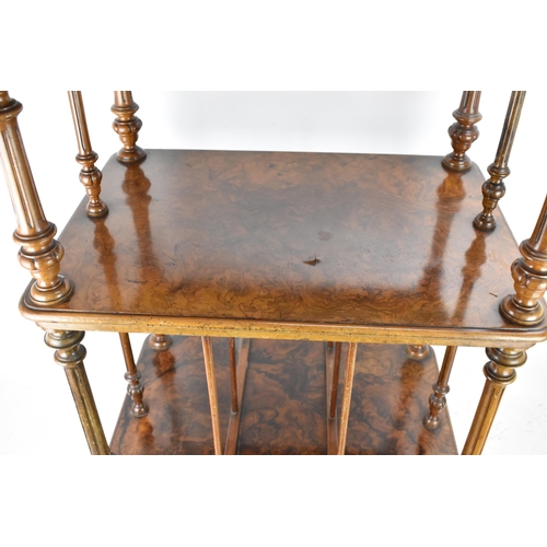 226 - A Victorian figured burr walnut three tier whatnot, having a gilt metal gallery top above three tier... 