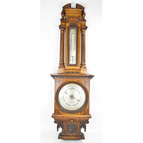 229 - A late Victorian/Edwardian Zegretti & Zambra oak cased barometer, the carved case having an open arc... 